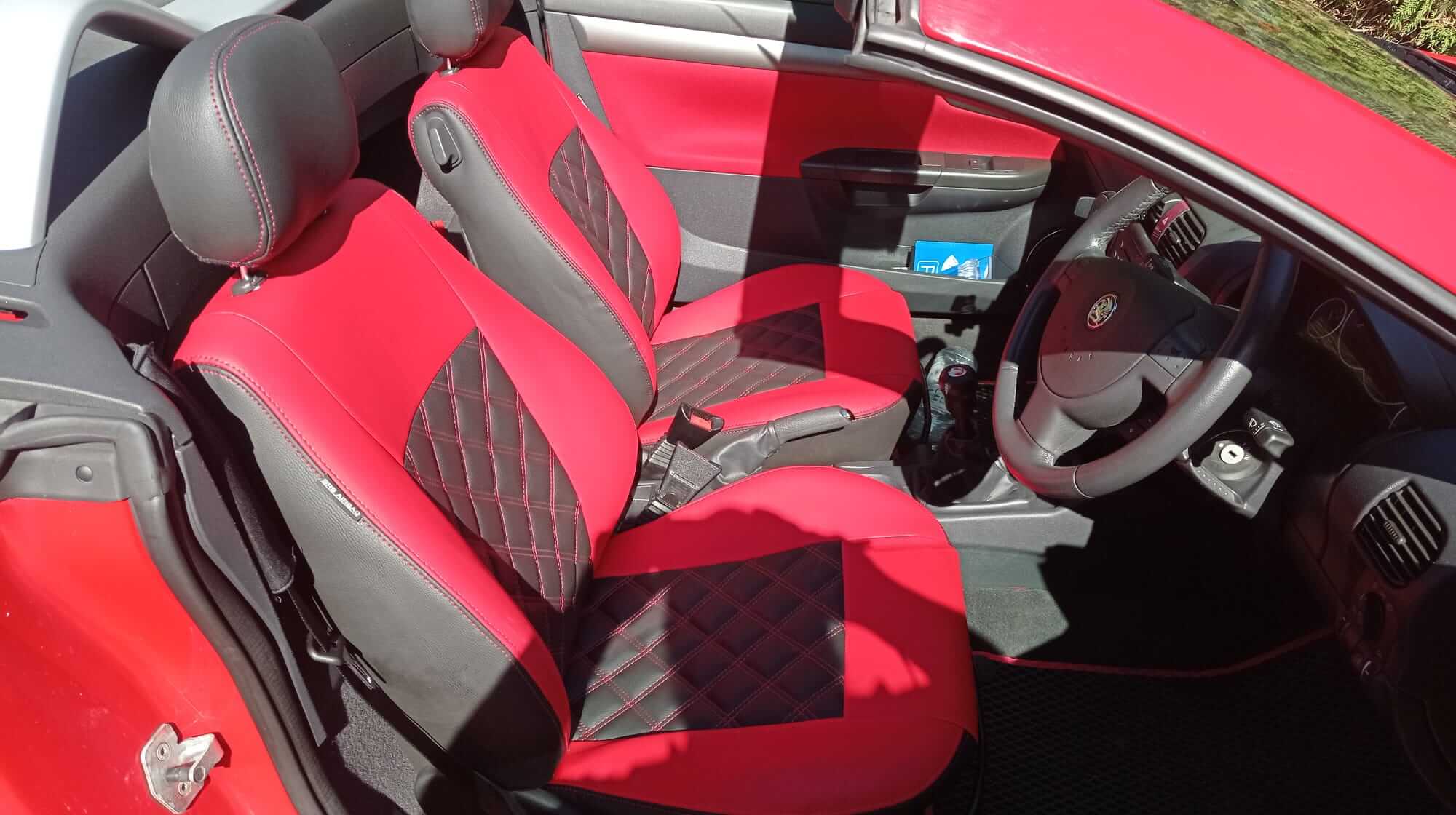 Opel Tigra Twintop Innenraum Sitzbezuege Rot Schwarz